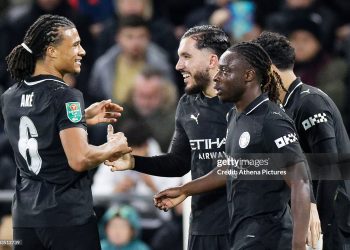 Rayan Cherki of Manchester City (2nd L) celebrates his goal with team mates Nathan Ake (L) and Jeremy Doku (R) during the Carabao Cup match between Swansea City and Manchester City (Photo by Athena Pictures/Getty Images)