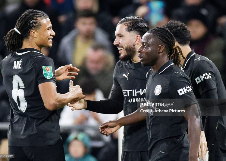 Rayan Cherki of Manchester City (2nd L) celebrates his goal with team mates Nathan Ake (L) and Jeremy Doku (R) during the Carabao Cup match between Swansea City and Manchester City (Photo by Athena Pictures/Getty Images)
