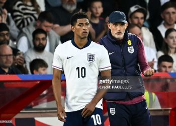 England's German head coach Thomas Tuchel (R) speaks to England's midfielder #10 Jude Bellingham as he prepares to enter the pitch (Photo by PAUL ELLIS/AFP via Getty Images)