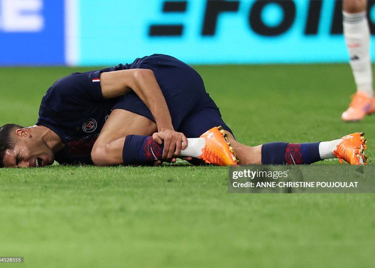 Paris Saint-Germain's Moroccan defender #02 Achraf Hakimi reacts after picking up an injury during the UEFA Champions League, league phase day 4, football match between Paris Saint-Germain (PSG) and FC Bayern Munich (Photo by ANNE-CHRISTINE POUJOULAT/AFP via Getty Images)