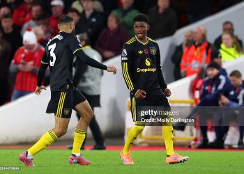 Amad Diallo of Manchester United celebrates scoring his team's second goal with teammate Noussair Mazraoui during the Premier League match between Nottingham Forest and Manchester United (Photo by Molly Darlington/Getty Images)
