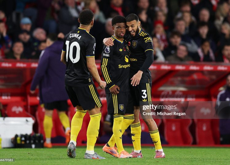 Amad Diallo of Manchester United celebrates scoring his team's second goal with teammates Noussair Mazraoui and Matheus Cunha during the Premier League match between Nottingham Forest and Manchester United (Photo by Michael Regan/Getty Images)