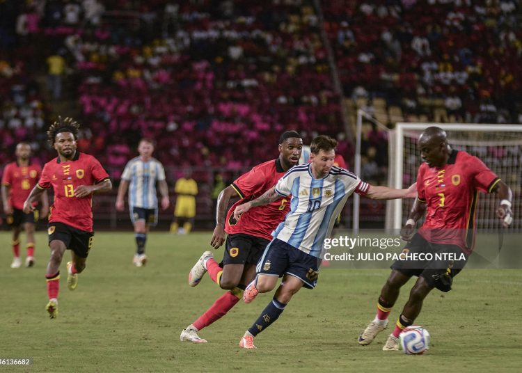 Argentina's forward #10 Lionel Messi (2nd R) vies for the ball with Angola's #3 Jonathan Buatu (R) and Angola's #6 Gaspar Kialonda (4th L) during the friendly match between Angola and Argentina in Luanda on November 14, 2025. Football icon Lionel Messi created the first goal and scored the second as world champions Argentina beat Angola 2-0 in an international friendly (Photo by JULIO PACHECO NTELA/AFP via Getty Images)