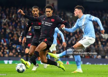 Phil Foden of Manchester City in action with Jarell Quansah of Bayer Leverkusen during the UEFA Champions League 2025/26 League Phase MD5 match between Manchester City and Bayer 04 Leverkusen  (Photo by Chris Brunskill/Fantasista/Getty Images)