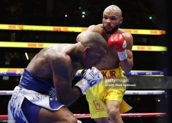 Chris Eubank Jr. (yellow shorts)  and Conor Benn (white and blue shorts) during their Middleweight Contest at Tottenham Stadium (Photo by Mark Robinson/Matchroom Boxing/Getty Images)