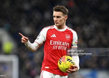 Martin Odegaard of Arsenal gestures to his teammates during the Premier League match between Everton and Arsenal (Photo by Stuart MacFarlane/Arsenal FC via Getty Images)