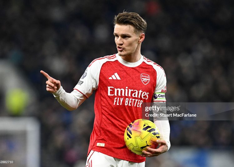 Martin Odegaard of Arsenal gestures to his teammates during the Premier League match between Everton and Arsenal (Photo by Stuart MacFarlane/Arsenal FC via Getty Images)