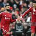 Liverpool's French striker #22 Hugo Ekitike (R) taps hands with Liverpool's Egyptian striker #11 Mohamed Salah as he comes off of the bench to play during the English Premier League football match between Liverpool and Brighton and Hove Albion (Photo by Paul ELLIS / AFP via Getty Images)