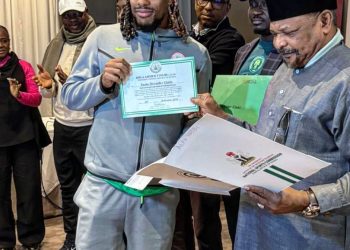 Alex Iwobi (left) receives land certificate from Nigeria National Sports Commission Photo Courtesy: Colin Udoh