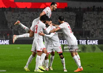Tunisia's midfielder #17 Ellyes Skhiri is congratulated by his teammates after scoring a goal during the Africa Cup of Nations (CAN) Group C football match between Tunisia and Uganda (Photo by Paul ELLIS / AFP via Getty Images)