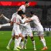 Tunisia's midfielder #17 Ellyes Skhiri is congratulated by his teammates after scoring a goal during the Africa Cup of Nations (CAN) Group C football match between Tunisia and Uganda (Photo by Paul ELLIS / AFP via Getty Images)