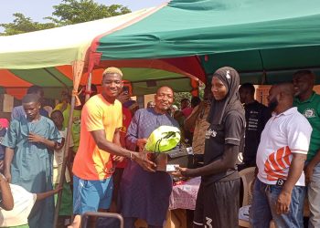 Maxwell Woledzi (left) presents items to 2025 Hijab Project Participant