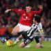 Benjamin Sesko of Manchester United is challenged by Sandro Tonali of Newcastle United during the Premier League match between Manchester United and Newcastle United (Photo by Carl Recine/Getty Images)