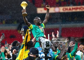 Senegal players celebrate with the trophy after winning the Africa Cup of Nations (CAN) final football match against Morocco (Photo by FRANCK FIFE / AFP via Getty Images)