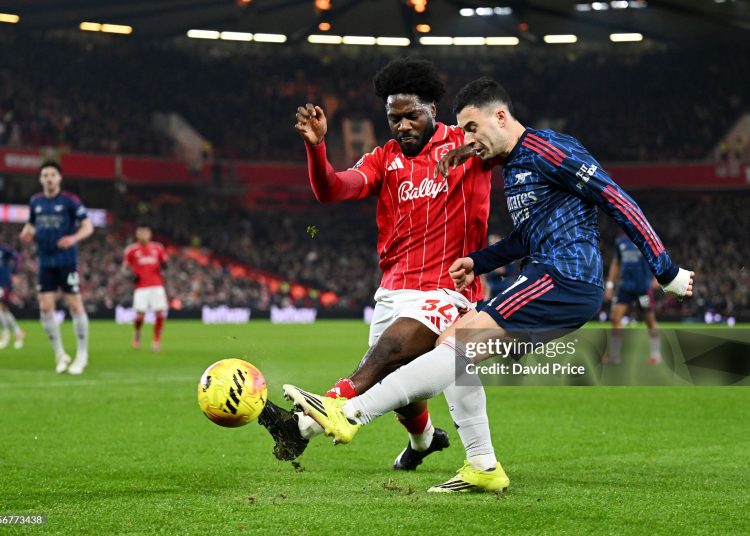 Gabriel Martinelli of Arsenal crosses the ball while under pressure from Ola Aina of Nottingham Forest during the Premier League match between Nottingham Forest and Arsenal (Photo by David Price/Arsenal FC via Getty Images)