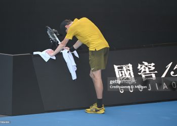 Jannik Sinner of Italy leans on the advertising boards in pain during the Men's Singles Third Round against Eliot Spizzirri of the United States during day seven of the 2026 Australian Open (Photo by James D. Morgan/Getty Images)