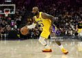 LeBron James #23 of the Los Angeles Lakers dribbles the ball during their game against the Sacramento Kings at Golden 1 Center on January 12, 2026 in Sacramento, California. James is wearing a patch to celebrate his 23rd NBA season (Photo by Ezra Shaw/Getty Images)