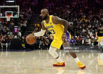 LeBron James #23 of the Los Angeles Lakers dribbles the ball during their game against the Sacramento Kings at Golden 1 Center on January 12, 2026 in Sacramento, California. James is wearing a patch to celebrate his 23rd NBA season (Photo by Ezra Shaw/Getty Images)