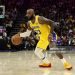 LeBron James #23 of the Los Angeles Lakers dribbles the ball during their game against the Sacramento Kings at Golden 1 Center on January 12, 2026 in Sacramento, California. James is wearing a patch to celebrate his 23rd NBA season (Photo by Ezra Shaw/Getty Images)