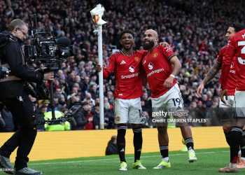 Manchester United's Cameroonian midfielder #19 Bryan Mbeumo (R) celebrates with Manchester United's Ivorian forward #16 Amad Diallo (C) after scoring the opening goal during the English Premier League football match between Manchester United and Manchester City (Photo by Darren Staples / AFP via Getty Images)