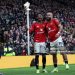 Manchester United's Cameroonian midfielder #19 Bryan Mbeumo (R) celebrates with Manchester United's Ivorian forward #16 Amad Diallo (C) after scoring the opening goal during the English Premier League football match between Manchester United and Manchester City (Photo by Darren Staples / AFP via Getty Images)