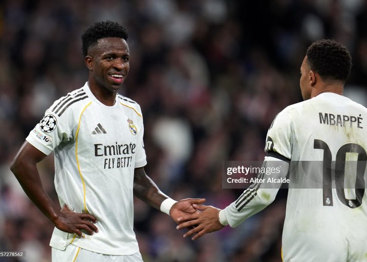Vinicius Junior of Real Madrid reacts with team mate Kylian Mbappe during the UEFA Champions League 2025/26 League Phase MD7 match between Real Madrid C.F. and AS Monaco (Photo by Aitor Alcalde/Getty Images)