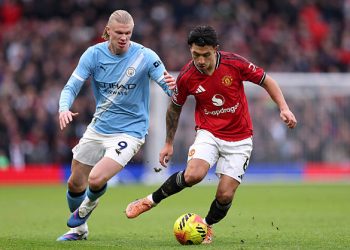Lisandro Martinez  is challenged by Erling Haaland during the Premier League match between Manchester United and Manchester City at Old Trafford on January 17, 2026 in Manchester, England. (Photo by Carl Recine/Getty Images)