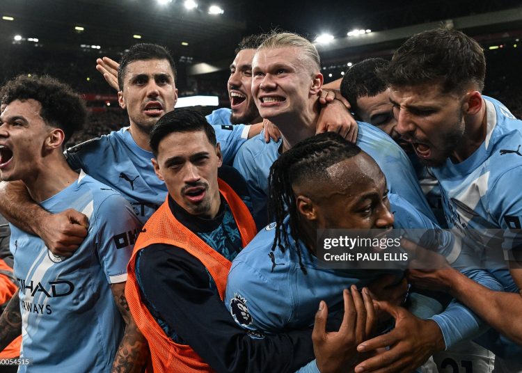 Manchester City's Norwegian striker #09 Erling Haaland (C) celebrates with teammates after scoring his team's second goal during the English Premier League football match between Liverpool and Manchester City (Photo by Paul ELLIS / AFP via Getty Images)