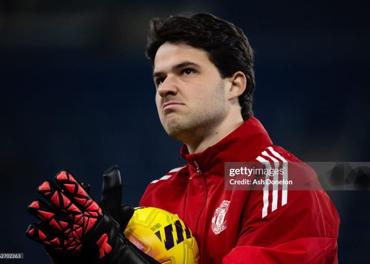 Senne Lammens of Manchester United warms up prior to the Premier League match between Everton and Manchester United (Photo by Ash Donelon/Manchester United via Getty Images)