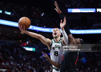 Kristaps Porzingis #8 of the Boston Celtics drives to the basket against Bam Adebayo #13 of the Miami Heat (Photo by Megan Briggs/Getty Images)