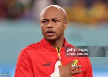 Andre Ayew of Ghana reacts during the line up for the National anthems prior to kick off in the FIFA World Cup Qatar 2022 Group H match between Ghana and Uruguay at Al Janoub Stadium on December 02, 2022 in Al Wakrah, Qatar. (Photo by Youssef Loulidi/Fantasista/Getty Images)