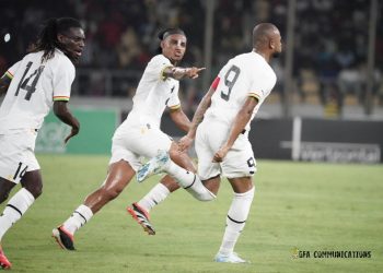 Razak Simpson celebrates scoring a goal with Black stars teammates