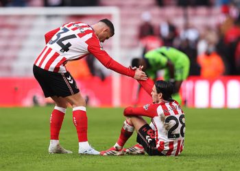 Granit Xhaka of Sunderland helps teammate Enzo Le Fee up as they reflect on defeat after the Premier League match between Sunderland and Fulham at Stadium of Light on February 22, 2026 in Sunderland, England. (Photo by George Wood/Getty Images)