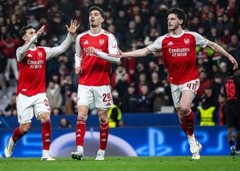 Kai Havertz of Arsenal (C) celebrates after scoring his team's first goal  with Martin Zubimendi (L) and Declan Rice m(R) during the UEFA Champions League 2025/26 Round of 16 First Leg match between Bayer 04 Leverkusen and Arsenal FC at BayArena on March 11, 2026 in Leverkusen, Germany. (Photo by Marvin Ibo Guengoer - GES Sportfoto/Getty Images)