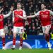 Kai Havertz of Arsenal (C) celebrates after scoring his team's first goal  with Martin Zubimendi (L) and Declan Rice m(R) during the UEFA Champions League 2025/26 Round of 16 First Leg match between Bayer 04 Leverkusen and Arsenal FC at BayArena on March 11, 2026 in Leverkusen, Germany. (Photo by Marvin Ibo Guengoer - GES Sportfoto/Getty Images)
