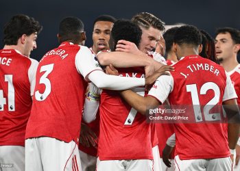 Bukayo Saka of Arsenal celebrates scoring his team's first goal with teammates during the Premier League match between Brighton & Hove Albion and Arsenal (Photo by David Price/Arsenal FC via Getty Images)