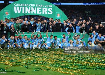 Tijjani Reijnders, Jeremy Doku, Antoine Semenyo, Erling Haaland, Gianluigi Donnarumma, Savinho, Pep Guardiola, Nathan Ake, Phil Foden, Bernardo Silva, Ruben Dias, Rodri, Erling Haaland, OMar Marmoush, Rayan Cherki, Savinho, Nico O'Rilley and Rico Lewis of Manchester City celebrate with the EFL Trophy after winning the Carabao Cup Final match between Arsenal and Manchester City (Photo by Nigel French/Sportsphoto/Allstar via Getty Images)