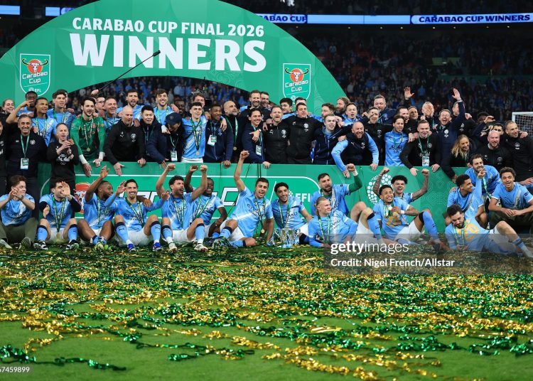 Tijjani Reijnders, Jeremy Doku, Antoine Semenyo, Erling Haaland, Gianluigi Donnarumma, Savinho, Pep Guardiola, Nathan Ake, Phil Foden, Bernardo Silva, Ruben Dias, Rodri, Erling Haaland, OMar Marmoush, Rayan Cherki, Savinho, Nico O'Rilley and Rico Lewis of Manchester City celebrate with the EFL Trophy after winning the Carabao Cup Final match between Arsenal and Manchester City (Photo by Nigel French/Sportsphoto/Allstar via Getty Images)