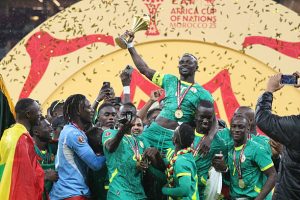 Senegalese players raise the trophy after winning the 35th Africa Cup of Nations (AFCON 2025) final match against Morocco at the Prince Moulay Abdellah Stadium in the capital Rabat, Morocco on January 19, 2026. Senegal won the 35th Africa Cup of Nations title on Sunday, defeating hosts Morocco 1-0 after extra time in a dramatic final marked by lengthy stoppage-time scenes