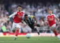 Joe Willock of Newcastle United is challenged by Martin Zubimendi of Arsenal during the Premier League match between Arsenal and Newcastle (Photo by Richard Heathcote/Getty Images)