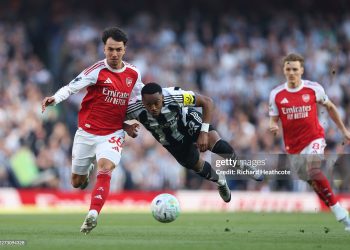 Joe Willock of Newcastle United is challenged by Martin Zubimendi of Arsenal during the Premier League match between Arsenal and Newcastle (Photo by Richard Heathcote/Getty Images)