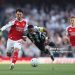 Joe Willock of Newcastle United is challenged by Martin Zubimendi of Arsenal during the Premier League match between Arsenal and Newcastle (Photo by Richard Heathcote/Getty Images)