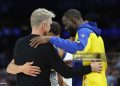 PHOENIX, ARIZONA - APRIL 17: Head coach Steve Kerr, Stephen Curry #30 and Draymond Green #23 of the Golden State Warriors hug during the final moments of an NBA play-in tournament game against the Phoenix Suns at Mortgage Matchup Center on April 17, 2026 in Phoenix, Arizona. The Suns defeated the Warriors 111-96.  NOTE TO USER: User expressly acknowledges and agrees that, by downloading and or using this photograph, user is consenting to the terms and conditions of the Getty Images License Agreement.  (Photo by Christian Petersen/Getty Images)