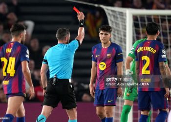 Referee Istvan Kovacs shows a red card to Pau Cubarsi of FC Barcelona following a VAR review after a challenge on Giuliano Simeone of Atletico de Madrid (not pictured) during the UEFA Champions League 2025/26 Quarter-Final First Leg match between FC Barcelona and Club Atlético de Madrid (Photo by Alex Caparros - UEFA/UEFA via Getty Images)