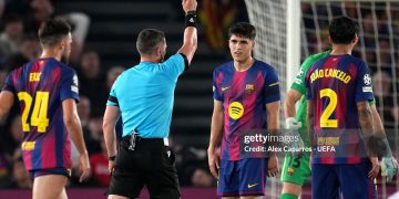 Referee Istvan Kovacs shows a red card to Pau Cubarsi of FC Barcelona following a VAR review after a challenge on Giuliano Simeone of Atletico de Madrid (not pictured) during the UEFA Champions League 2025/26 Quarter-Final First Leg match between FC Barcelona and Club Atlético de Madrid (Photo by Alex Caparros - UEFA/UEFA via Getty Images)