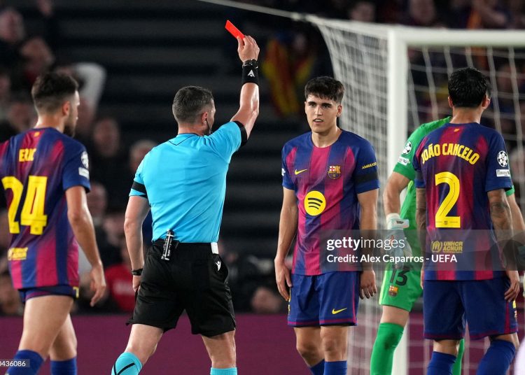 Referee Istvan Kovacs shows a red card to Pau Cubarsi of FC Barcelona following a VAR review after a challenge on Giuliano Simeone of Atletico de Madrid (not pictured) during the UEFA Champions League 2025/26 Quarter-Final First Leg match between FC Barcelona and Club Atlético de Madrid (Photo by Alex Caparros - UEFA/UEFA via Getty Images)