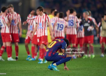 Lamine Yamal of FC Barcelona reacts by crouching with his head down, looking at the grass following his team’s defeat to Club Atlético de Madrid during the UEFA Champions League 2025/26 Quarter-Final First Leg match between FC Barcelona and Club Atlético de MADRID (Photo by Pedro Salado/Getty Images)