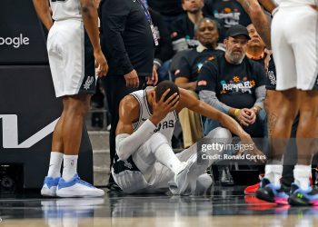 Victor Wembanyama #1 of the San Antonio Spurs holds his head after falling to the court against the Portland Trailblazers in the first half  of Game Two of the Western Conference First Round NBA Playoffs (Photo by Ronald Cortes/Getty Images)