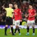 Referee Paul Tierney sends off Manchester United's Lisandro Martinez (right) during the Premier League match (Photo by Martin Rickett/PA Images via Getty Images)