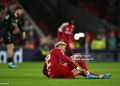 Hugo Ekitike of Liverpool holds his ankle as he appears to be injured during the UEFA Champions League 2025/26 Quarter-Final Second Leg match between Liverpool FC and Paris Saint-Germain FC (Photo by Liverpool FC/Liverpool FC via Getty Images)